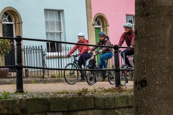 Group of commuters riding along the canal in Bristol